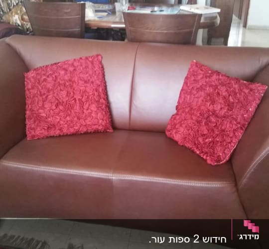 ספה חומה עם כריות אדומות מעוצבות
